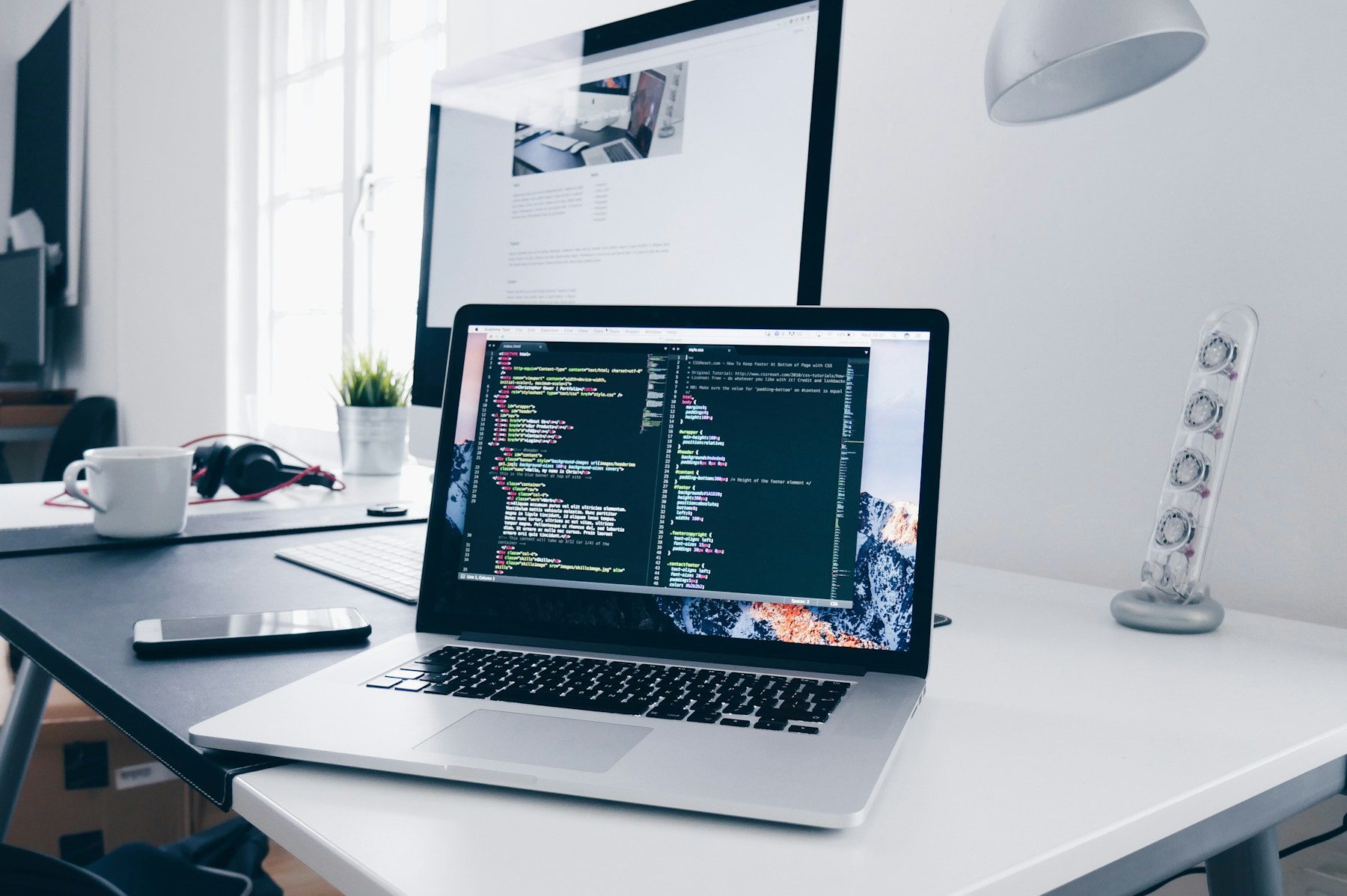 Developer workspace with code displayed on a desktop monitor.